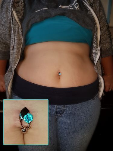 a woman's stomach with a ring attached to the side and an image of her belly