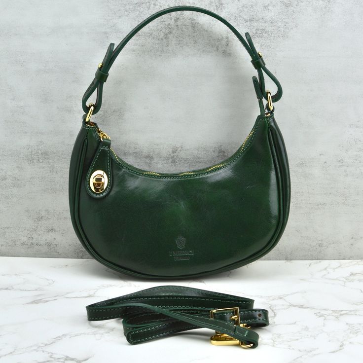 Compact yet spacious, this bag adds an effortless touch of elegance to any outfit. Made with high-quality leather, it's the perfect blend of fashion and function. (Oh, and it's perfect for a night out!) Dimensions: 9.5" L x 12.5"H (including handle) x 2.5" W Handmade in Florence, Italy Luxurious Italian leather tanned using traditional vegetable methods. Sleek metal zipper with front notch closure for secure storage Gold hardware. Detachable leather shoulder strap, 45" Fabric lining with a conve Elegant Leather-lined Crossbody Shoulder Bag, Timeless Evening Bag For Everyday Use, Luxury Everyday Shoulder Bag With Round Handle, Elegant Everyday Baguette Bag With Round Handle, Designer Leather Baguette Bag For Shopping, Elegant Bucket Shoulder Bag With Leather Lining, Luxury Crossbody Hobo Bag For Shopping, Elegant Baguette Bag With Detachable Strap And Round Handle, Elegant Soft Leather Evening Bag For Shopping