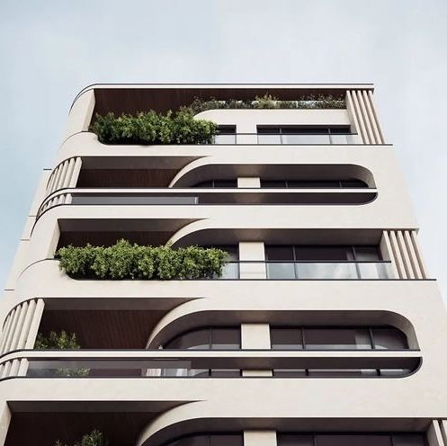 an apartment building with plants growing on the balconies