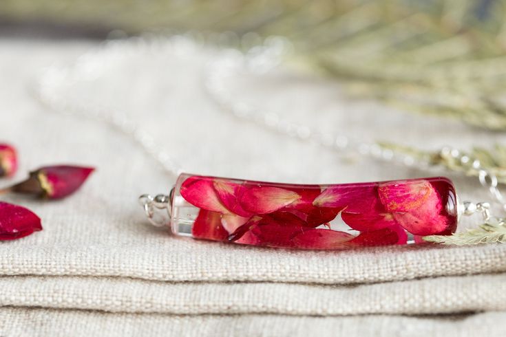 "This beautiful necklace is filled with real rose petals in a gorgeous shade of red... it's wonderfully romantic and elegant and so very peaceful. It is made of extra strong, jewellery grade clear resin so it catches and refracts the light gorgeously. The pendant is 45mm across and ever so slightly curved, and comes on a sterling silver chain. The full length of the necklace, including the chain, is 20\" (51cm)." Red Roses Necklaces For Gift, Red Rose Necklaces For Gifts, Red Rose Necklace For Gift, Gift Red Rose Necklaces, Red Flower-shaped Necklace With Rose Design, Red Flower Necklace With Rose Design, Red Rose Design Flower Necklace, Red Floral Rose Design Necklace, Red Rose Design Necklace For Wedding