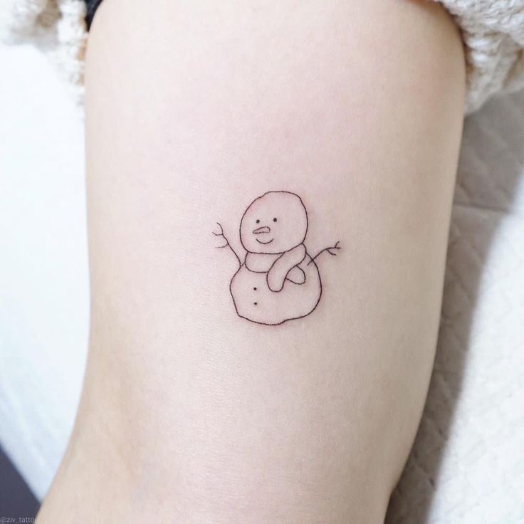 a small tattoo on the leg of a woman with a bear in it's arms