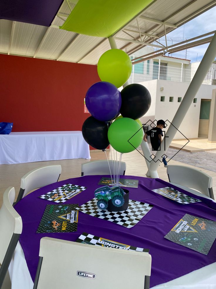 a purple table topped with lots of balloons