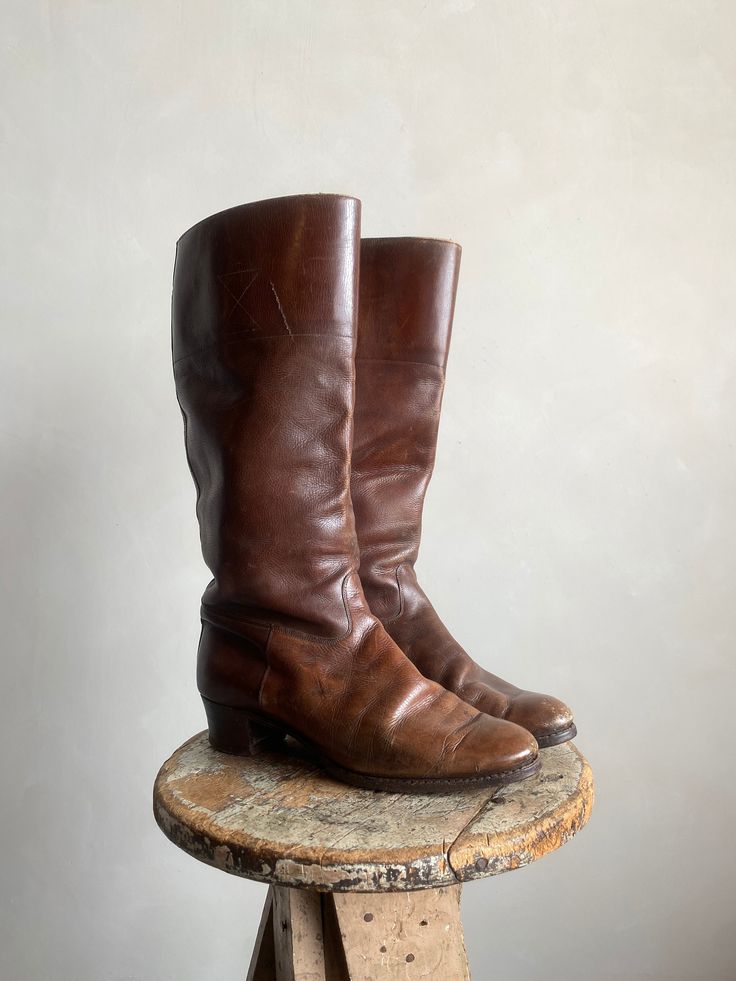 "Vintage 40s The Bedggood English Riding Leather Boots. Brown in color made from genuine leather. Tall slip on style riding boot. Condition overall is good with only minor flaws that include; Minor leather scuffs throughout. No rips or tears. Leather is soft and still in great shape. Minimal wear on bottom soles. Please see all photos for details. Refer to measurements below to ensure a proper fit  9.5\" heel to toe 3\" wide toe box 15\" in total length (1.25\" heel)" Classic Vintage Brown Boots For Fall, Vintage Leather Moto Boots For Fall, Retro Leather Knee-high Boots With Round Toe, Retro Knee-high Leather Boots, Vintage Leather Riding Boots, Vintage Fall Moto Boots With Leather Lining, Vintage Riding Boots For Fall, Vintage Brown Knee-high Moto Boots, Vintage Leather Boots For Work