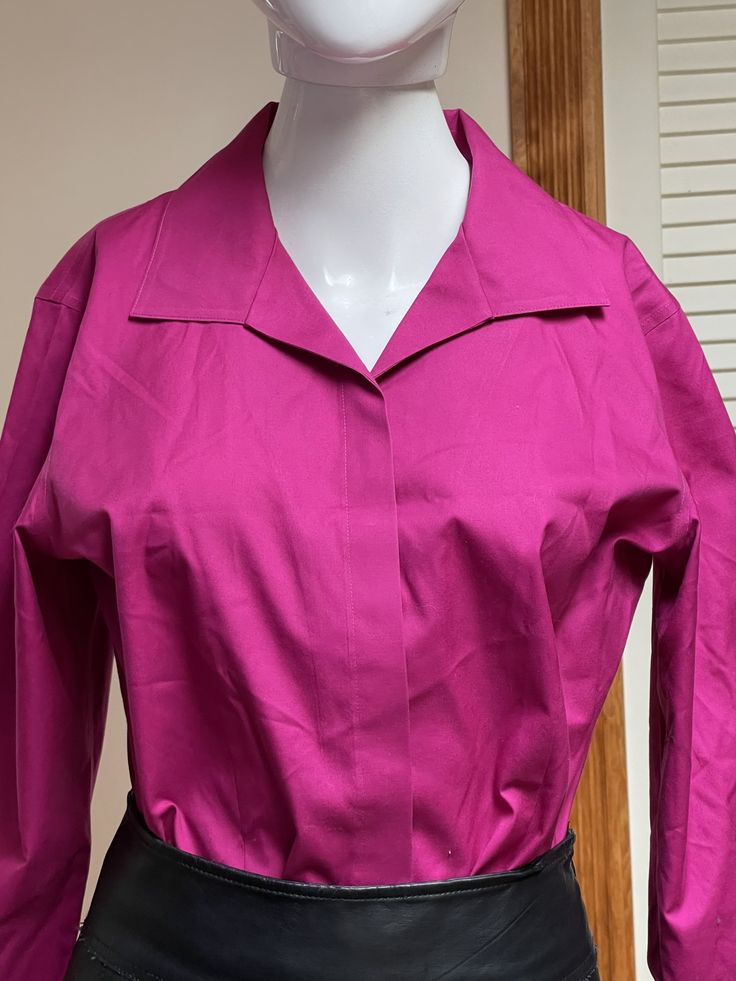 "Beautiful Y2K modern vintage hot fuscia pink shirt / blouse.  Front buttons has chic covering panel.  Three-quarters sleeves with rolled cuffs.  Lovely soft shawl collar with gently pointed tips.  Gorgeous workwear / job interview shirt that looks great as casual wear too! Unisex adult / gender neutral.  💥Condition: Excellent vintage condition.  💥Material: Cotton  Please see measurements before buying.  💥MEASUREMENTS💥 Measurements are taken while the garment is lying flat. Please double where appropriate for actual dimensions. Approximate Measurements (lying flat, buttoned): Width Armpit to Armpit: 20.5\" Width of Bottom Hem: 21\" Length from Shoulder Top to Bottom Hem: 24\" Please be sure the approximate measurements are a good fit for you. We're happy to answer questions or provide Fitted Blouse With Buttons And Lapel Collar, Fitted Blouse With Lapel Collar And Buttons, Spring Party Shirt With Spread Collar, Office Blouse With Covered Buttons And Collar, Fitted Solid Color Blouse With Placket, Spring Party Top With Spread Collar, Classic Pink Tops With Collared Neckline, Classic Pink Collared Top, Collared Fitted Blouse With Placket