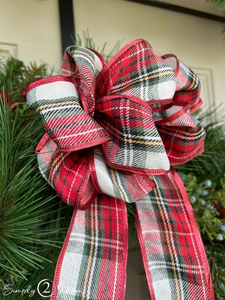 a red, white and black plaid bow on a christmas wreath