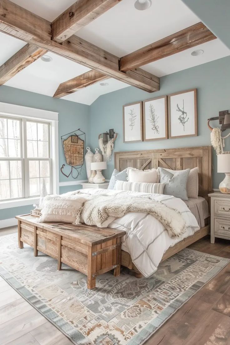 a bedroom with blue walls and wooden beams in the ceiling, along with a large bed