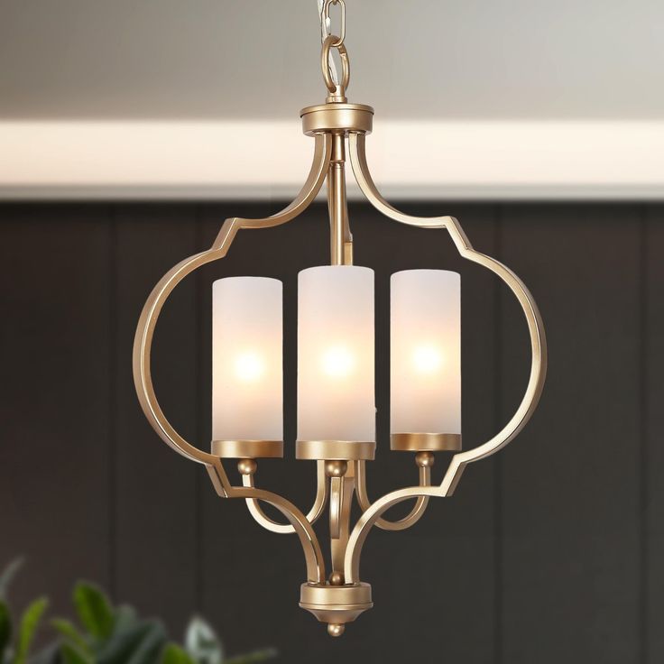 Lighting is an important part of the ensemble home decor. Not only can a chandelier elevate the look of the room, but as a core piece to narrate the owner's spirit and character. This 3-light matte gold with cylinder frosted glass shades globe chandelier light is designed in finely mill work sleek cage shape, constructed of durable wrought iron in matte gold and frosted cylinder shade to add much modern stylish, and boost maximum ambiance to your dining room, bedroom, living room, Kitchen island Small Chandeliers, Mill Work, Parlor Room, Hanging Pendant Light, Small Chandelier, Globe Chandelier, Glass Lantern, Chandelier Light, Hanging Pendant