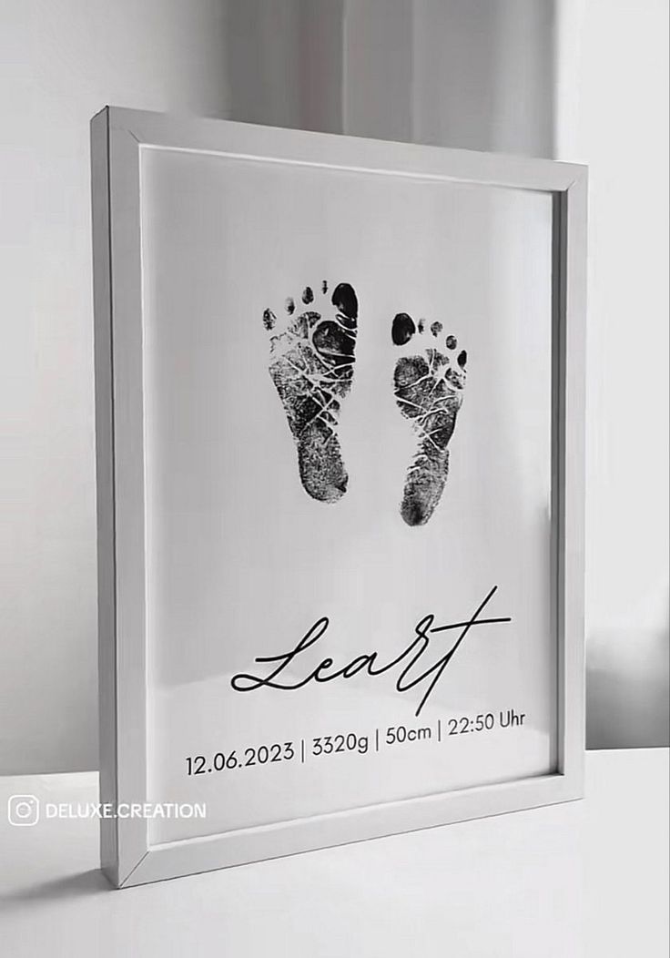 a baby's hand and foot print is shown in a glass frame with the words leafft on it