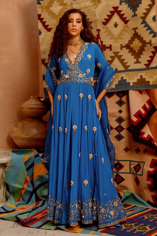 cobalt blue V-neck anarkali embroidered in dori, dabka and pearl work with gota patti. Comes with bias pant and dupatta.
Components: 3
Pattern: Embroidered
Type Of Work: Floral
Neckline: V Neck
Sleeve Type: Three Quarter
Fabric: Kurta- wrinkle crepe, Bias pant- silk blend, Dupatta- Organza, Kurta lining- Shantoon, Pant lining- Mulmul
Color: Blue
Other Details: 
Closure:
Kurta- front hook
Pant- side zip
Occasion: Wedding - Aza Fashions Transitional Season Blue Anarkali Lehenga, Blue Festive Anarkali Set With Traditional Drape, Blue Anarkali Set For Festive Occasions, Festive Blue Anarkali Set With Traditional Drape, Transitional Blue Anarkali Set With Zari Work, Blue Anarkali Set With Zari Work For Transitional Season, Blue Resham Embroidered Anarkali Set For Navratri, Blue Anarkali Set With Resham Embroidery For Navratri, Anarkali Style Lehenga With V-neck And Resham Embroidery