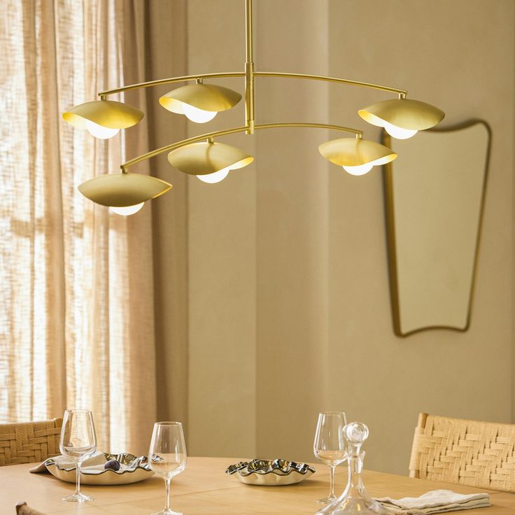 a dining room table with place settings and wine glasses