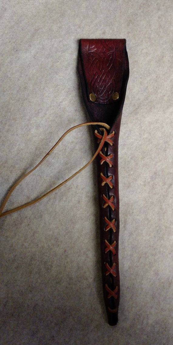 an old fashioned leather case is laying on the floor next to a string that has been tied up