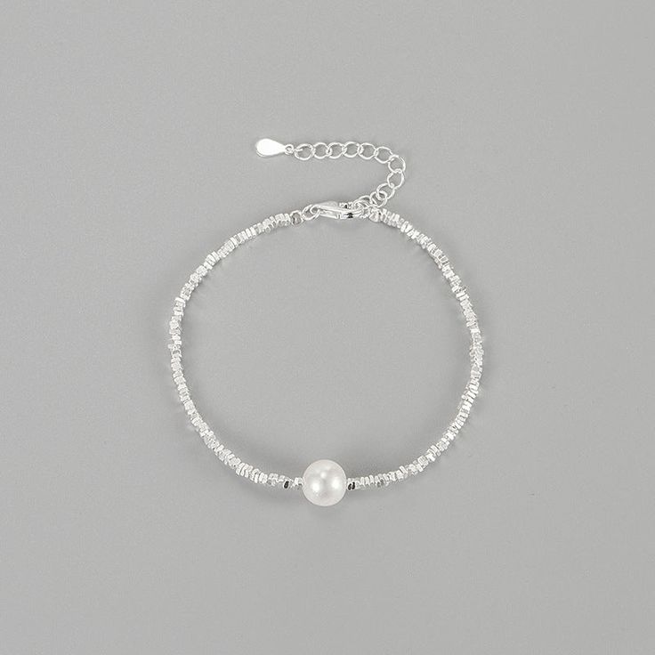 Elevate your wrist with our stunning Natural Pearl Sterling Silver Bracelet. Crafted with genuine pearls and high-quality sterling silver, this bracelet exudes elegance and sophistication. The natural pearls add a touch of luxury, making it a perfect accessory for special occasions or everyday wear. Embrace timeless beauty with this exquisite bracelet that will effortlessly enhance your style. Material: 925 Sterling Silver Stone: 8mm Natural Freshwater Pearl Length: 16+3cm Pearl Charm Beaded Bangle Bracelet, Pearl Bangle With Pearl Charm, Elegant Silver Crystal Bracelet With Pearl Charm, Adjustable Sterling Silver Bracelet With Pearls For Gift, Pearl Bracelets With Silver Beads As A Gift, Silver Beaded Bracelets With Pearl Charm As Gift, Pearl Bracelets With Silver Beads For Gifts, Gift Pearl Bracelets With Silver Beads, Adjustable Sterling Silver Pearl Bracelet For Gift