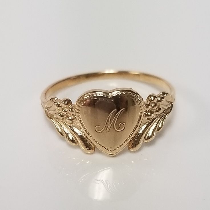 Thanks for shopping our vintage estate store. We tend to sell well below wholesale and truly hope you enjoy all of our items. Many of the items are one of a kind, so please enjoy scrolling through the pictures and hopefully something will catch your eye. Brown spots are from camera or reflections. Estate 14k yellow gold monogram cursive capital M heart ring. Custom made ring for our shop. Ring size: 3  Setting: 7.5mm 1/4" to 3/8"  Band width: 1.4mm Weight: 1.09 grams Marked 14k and it's sweet. O Mariah Core, Cursive M, Antique Style Rings, Lifestyle Women, Dope Jewelry, Gold Link, Gold Monogram, Funky Jewelry, Jewelry Lookbook