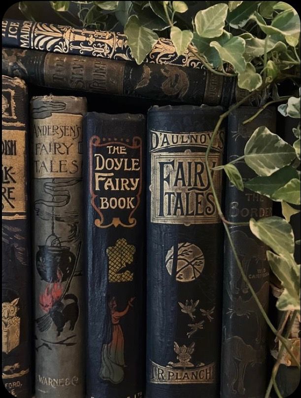 there are many books on the shelf with plants growing out of them in front of it