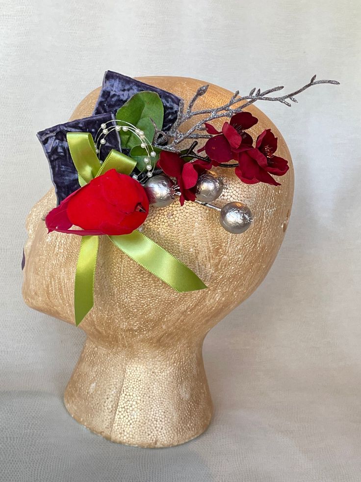 "Dress up your darling hair-do with this vintage-inspired Christmas fascinator adorned with bright Christmas cardinal bird, periwinkle crushed velvet ribbon, lime ribbon, silver berries and red glitter flowers.  Includes an alluring snowy glitter branch to add a little chic charm that will be sure to turn heads.  Inspired by my love of 1940's actresses who always were dressed to the 9's. I imagine wearing this to a coffee, afternoon tea or book club where the ladies get down to gossip,  gabbing and chisme while showing off their fabulous suits and dresses to each other. The alligator clip makes this adornment very versatile: it can be worn in any position on the head, or can even be attached to a blouse, bracelet, hat or worn as a corsage to bring more beauty to your day. Express your rega Whimsical Red Headband Style Headpiece, Red Whimsical Headband Style Headpiece, Red Whimsical Mini Hats For Gifts, Whimsical Red Mini Hats For Gifts, Whimsical Handmade Flower Hair Accessories, Whimsical Handmade Flower Hair Accessories For Gifts, Whimsical Red Mini Hats As Gifts, Whimsical Handmade Flower Hair Accessories As Gift, Adjustable Holiday Headpieces For Gifts