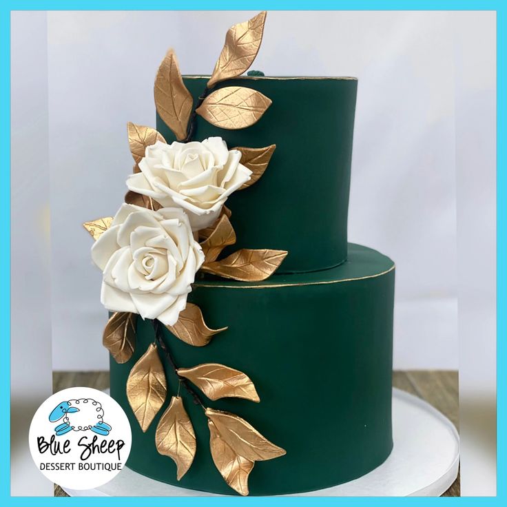 a green and gold wedding cake with white flowers