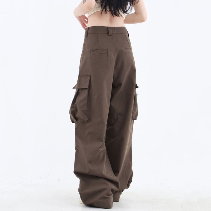 These classic-style brown pants feature a wide fit with cargo pockets Size: • S: Waist: 62cm/ 24.4 in, Length: 100cm/ 39.4 in• M: Waist: 66cm/ 26.0 in, Length: 101cm/ 39.8 in• L: Waist: 70cm/ 27.6 in, Length: 102cm/ 40.2 in• XL: Waist: 74cm/ 29.1 in, Length: 103cm/ 40.6 in• XXL: Waist: 80cm/ 31.5 in, Length: 104cm/ 40.9 inMaterial: Cotton, Polyester Baggy Brown Long Pants, Brown Full-length Parachute Pants For Streetwear, Brown Bottoms With Side Pockets For Fall, Brown Baggy Full-length Cargo Pants, Baggy Brown Bottoms With Side Pockets, Brown Baggy Bottoms With Side Pockets, Baggy Khaki Bottoms With Flap Pockets, Brown Baggy Cargo Pants For Fall, Khaki Wide Leg Cargo Style Bottoms