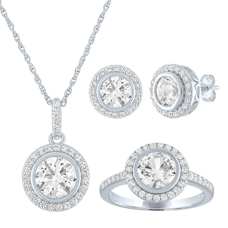 Dramatic with clean lines and radiant dazzle, this gemstone set features round lab-created white sapphire earrings with a matching pendant and ring. Each coordinated accessory features a lab-created white sapphire halo for graphic glam in sterling silver. Wear pieces separately or grouped for added impact. Our gift sets go the extra mile, made for sharing with someone special. Triple a surprise or treat yourself to a little sparkle. Formal Halo Lab Grown Diamond Jewelry, Modern Diamond Jewelry With Halo Design, Round Lab Grown Diamond Jewelry With Halo, Round Lab-grown Diamond Jewelry With Halo, Lab Grown Diamond Halo Jewelry, Halo Round Lab Grown Diamond Jewelry, Diamond White Topaz Jewelry With Halo Design, Fine White Topaz Jewelry With Halo Design, White Diamond Jewelry With Halo Design