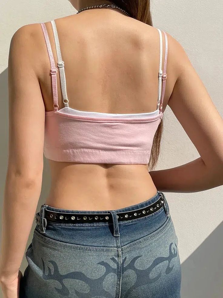 This sweet, soft-hued crop top offers a playful yet chic vibe, ideal for creating layered looks. Its delicate bow and button detail add a touch of youthful charm, perfect for a sunny day out or a casual hangout with friends. Pair with high-waisted jeans and a statement belt for an effortlessly stylish ensemble. Soft girl aesthetic Layered design Double adjustable straps Button detail at front Bow detail on chest Elasticated hem Polyester, spandex Pink Tops With Built-in Bra For Day Out, Feminine Spring Crop Top With Built-in Bra, Pink Crop Top With Built-in Bra, Trendy Cropped Crop Top For Day Out, Cropped Cotton Tops With Built-in Bra, Cute Crop Top For Day Out, Chic Cotton Crop Top For Spring, Chic Spring Cotton Crop Top, Spring Chic Cotton Crop Top