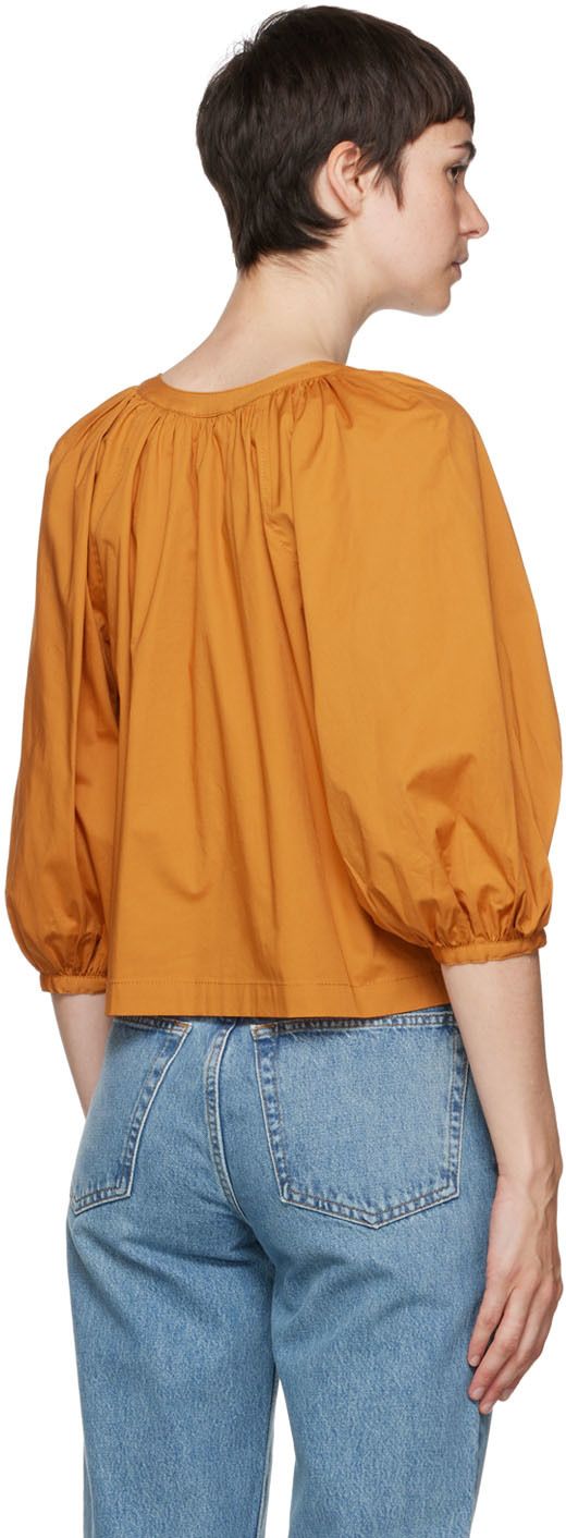 Stretch cotton poplin blouse. Gathering at collar and cuffs. · Y-neck · Button closure · Puff sleeves · Single-button cuffs Supplier color: Honey Poplin Blouse, Collar And Cuff, Cotton Poplin, Puff Sleeves, Stretch Cotton, Puff Sleeve, Ruffle Blouse, Honey, Long Sleeve Blouse