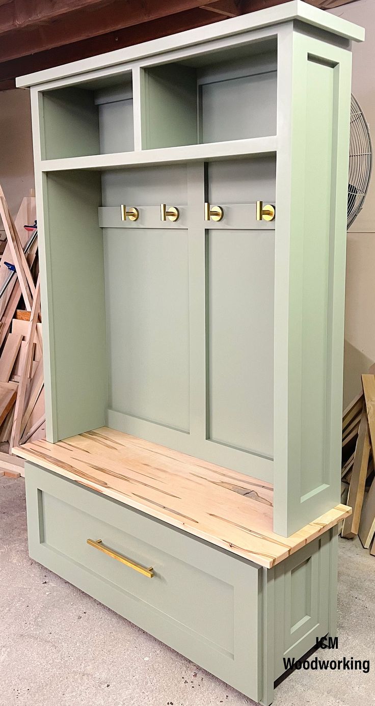 a wooden bench with two doors and drawers on it's sides in a shop