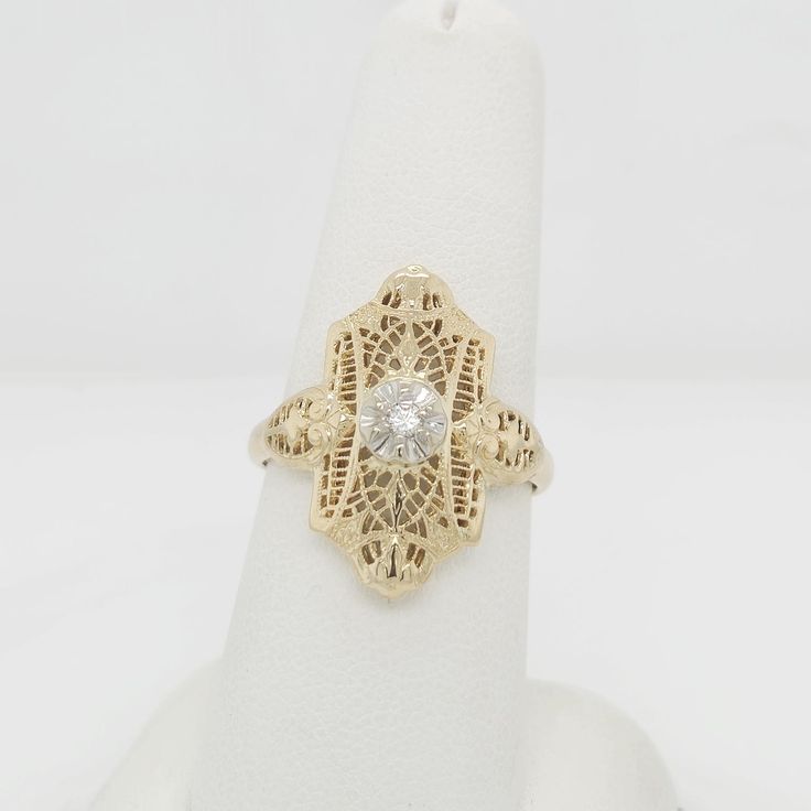 Discover timeless beauty with this stunning 14k gold ring featuring a sparkling diamond at its center. With its classic design, this size 8 ring measures 22mm x 11mm, offering a touch of luxury for any occasion. Elegant Rose Gold Engraved Ring Stamped 14k, Antique Diamond Ring With Center Stone, Antique Diamond White Diamond Ring, 14k Gold Diamond White Signet Promise Ring, 14k Gold Brilliant Cut Diamond White Halo Ring, 14k Gold Halo Ring With Brilliant Cut Diamond White, Gold Diamond Cluster Ring Stamped 14k, Antique Oval Single Diamond Ring, Antique Oval Diamond Ring With Single Diamond