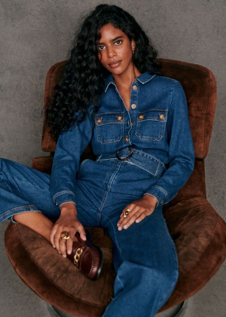 Long-sleeved jumpsuit with open wrists;Front button placket and a zip;Straight leg;Italian front and back patch pockets;Removable belt with buckle;Inside leg length 81 cm / 31.8 in (for a size 36) Retro Denim Jumpsuit, Dark Denim Jumpsuit, Worship Outfits, Denim Jumpsuit Outfit, Jean Fits, Denim Party, Women Wearing Ties, Trousers Jeans, French Beauty