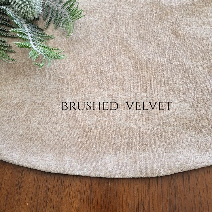 a close up of a table with a plant on it and the words brushed velvet