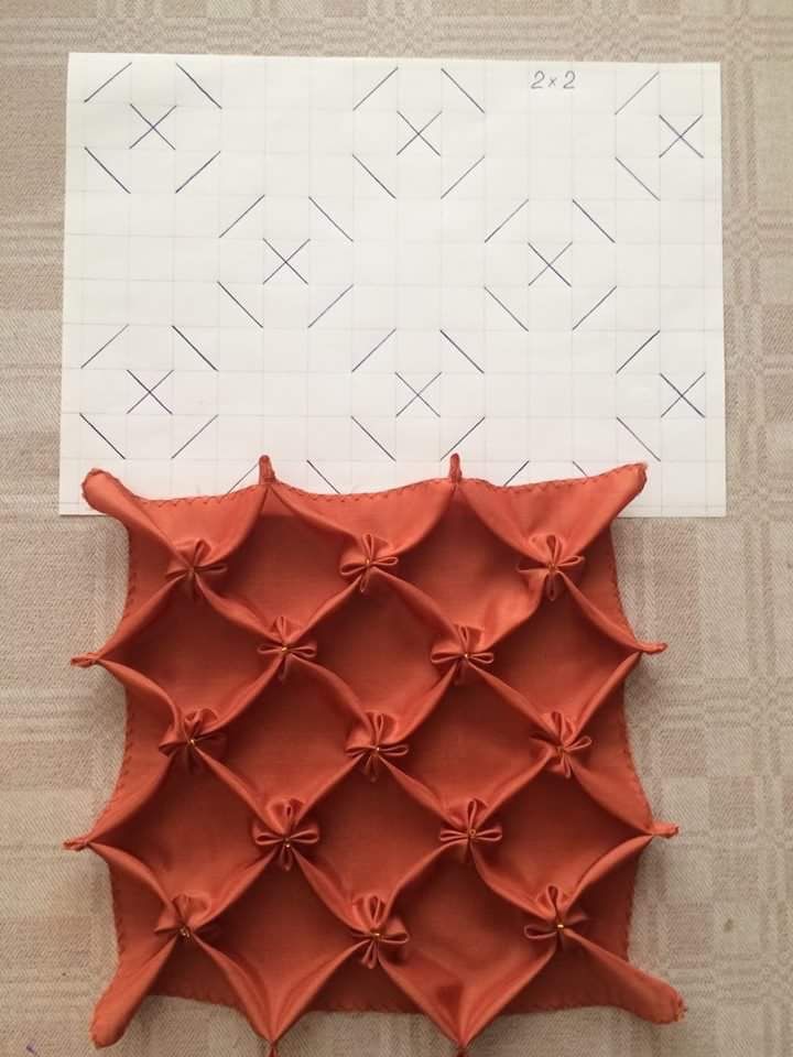 an orange piece of paper with some scissors on it next to a cut out pattern