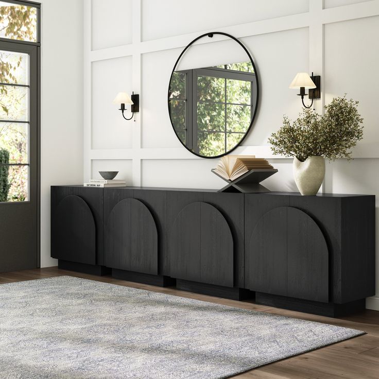 a room with a rug, mirror and vases on the sideboard in front of it