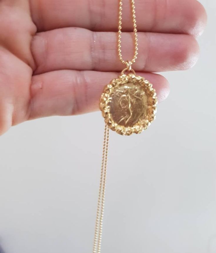 Gold coin necklace, gold pendant necklace, 14k gold necklace, antique coin necklace, medallion necklace, long coin necklace Long 14k gold filled necklace with an antique gold coin pendant, decorated with golden hammered beads. Beautiful minimalist round pendant, designed in an antique style, this gold coin medallion necklace is just a great gift for her It will be your to go necklace, for day or night, never needing to to take it off. Dimensions: The coin medallion pendant diameter is about 0.75 Engraved Brass Medallion Coin Necklace, Yellow Gold Medallion Coin Necklace In Brass, Antique Brass Coin Necklace With Round Pendant, Gold Plated Engraved Coin Medallion Necklace, Brass Necklaces With Coin Pendant In Round Disc Shape, Gold Brass Coin Necklace, Gold Brass Round Disc Coin Necklace, Yellow Gold Brass Coin Necklace With Round Pendant, Brass Necklaces With Coin Pendant