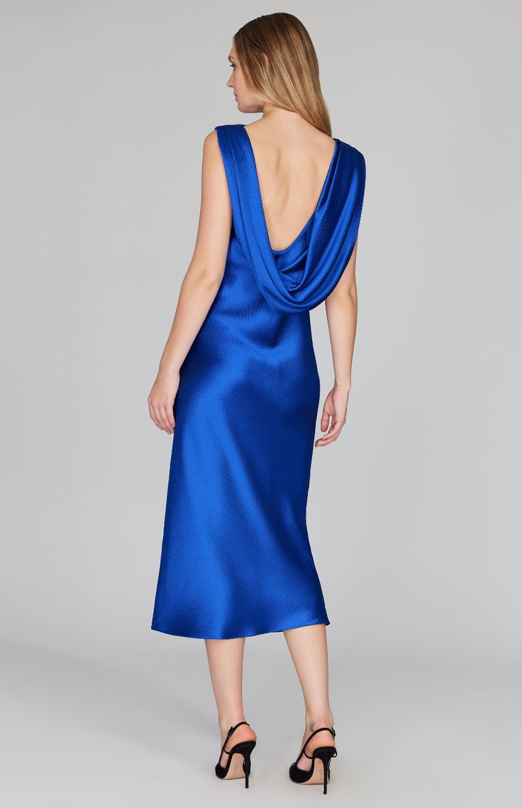 Our signature bias cut silhouette, updated with a gracefully draped front and low back detail. Cut in a flattering midi length with a clean baby hem finish. This dress is unlined and needs no closures thanks to the nature of bias cut fabric. Blue Party Dress With Cowl Back, Blue Cowl Back Dress For Party, Evening Midi Dress With Bias Cut And Cowl Neck, Evening Midi Dress With Ruched Back, Knee-length, Elegant Midi Dress With Bias Cut And Cowl Back, Elegant Blue Cowl Neck Dress, Blue Cowl Neck Party Dress, Fitted Bias Cut Midi Dress With Cowl Neck, Elegant Blue Midi Dress With Ruched Back