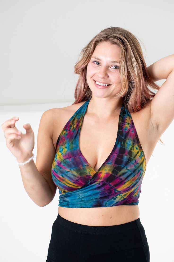 We took one of our favorite tops evenfurther into the psychedelic colorful explosion of hippie fashion.The perfect top for athletic or casual endeavors, it can be wornas an undergarment ora boho bralette, as a supportive garment when exercising, as a swimsuit top, or allon its own as a cuteboho statement top. Tied in the front, or tied around back, it doesn't matter as it is all groovy as long as it's Tie Dye. Yoga Wrap Top, Colorful Explosion, Stretchy Crop Tops, Hippie Fashion, Tie Dye Designs, Purple Teal, Doesn't Matter, Swimsuit Tops, Wrap Top