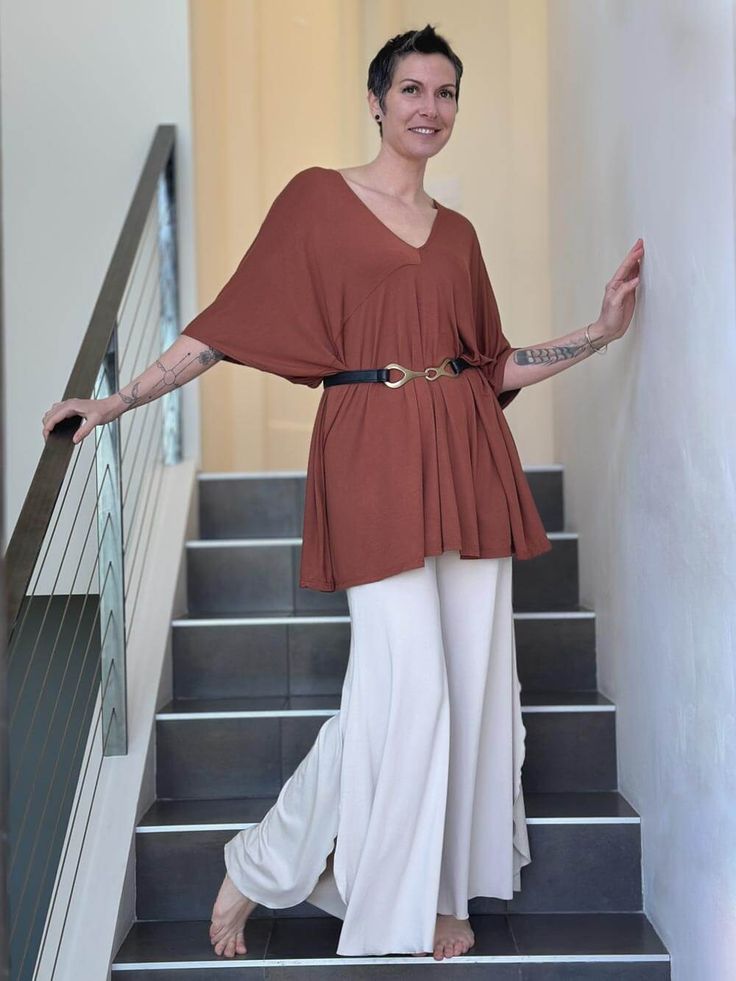 Butterfly Tunic Dress Whether you're lounging poolside or out at a summer gathering, this oversized and airy silhouette can be worn as a beach cover-up or mini dress by day or layered over your favorite pants or jeans for a more sophisticated look. For a personalized touch, try cinching the waist with a stylish belt to accentuate your curves and add definition to your ensemble. Whether you prefer a bohemian-inspired vibe or a more polished aesthetic, this tunic dress is effortlessly versatile. Embrace endless possibilities with our Butterfly Tunic Dress — from the beach to the streets and beyond. One Size (O/S): 4-14 ColorsAvailable in these colors: Jam Copper Navy Plum Teal Black Product Features Can be worn as a mini-dress or tunic Oversized Empire waist Open back V neckline in front and Chic Tunic Cover-up For Beach Season, Chic Spring Unlined Cover-up, Chic Unlined Spring Cover-up, Spring V-neck Tunic For Loungewear, Oversized V-neck Tunic For Beach Cover-up, Spring V-neck Beach Dress, Summer Relaxed Loungewear Cover-up, Relaxed Summer Loungewear Cover-up, Flowy V-neck Cover-up For Brunch