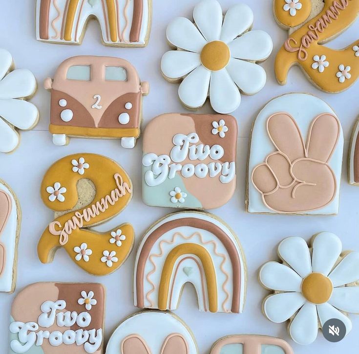 decorated cookies are arranged on a white surface