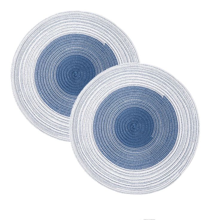 two blue and white plates sitting next to each other on top of a white surface