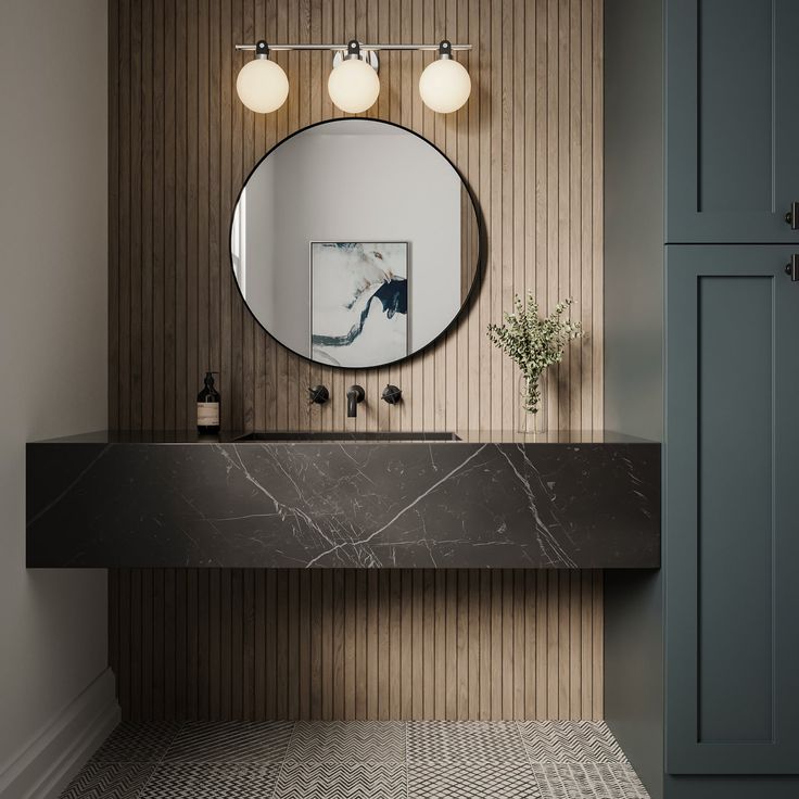 a bathroom with a marble sink and mirror