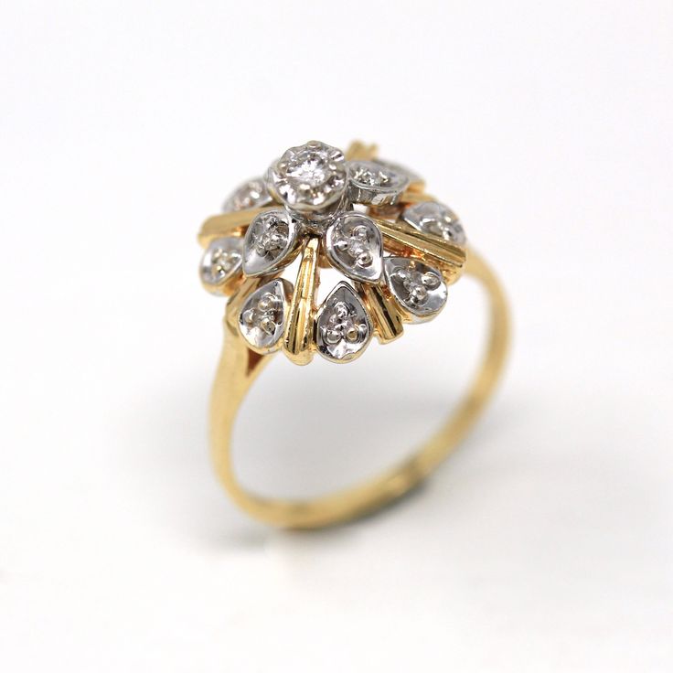 an antique diamond cluster ring in yellow gold