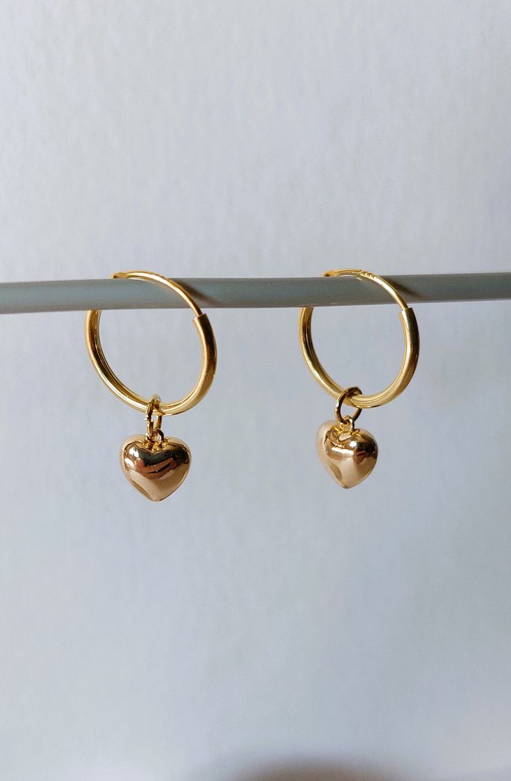 925 sterling silver gold plated hoop earrings, 14mm diameter, with an 18k gold plated heart. Length of the earring is 25 mm. The 18 carat gold filling is approx. 100 times thicker than with simple gold plating. The gold layer is mechanically bonded to the brass base material Goldfilled is resistant to abrasion under normal use. Small inclusions, color deviations and irregularities on the pearls or on the metals are part of the peculiarity of the materials. If you have special requests, want unusual pieces of jewelry, please feel free to contact me. More beautiful pieces of jewelry can be found here: https://www.etsy.com/de/shop/MerlesSchmuckArt Handmade Dainty Gold Huggie Earrings, Handmade Gold Dainty Huggie Earrings, Hoop Jewelry With Heart Charm For Anniversary, Small Hoop Earrings With Heart Charm For Anniversary, Small Hoop Jewelry With Heart Charm For Anniversary, Minimalist Hoop Earrings With Heart Charm For Anniversary, Gold Earrings With Heart Charm In 14k Gold Filled, Gold Sterling Silver Hoop Earrings For Gift, Gold Huggie Jewelry Gift For Her