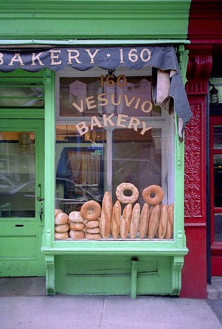 there are many doughnuts in the window of this bakery shop that sells them