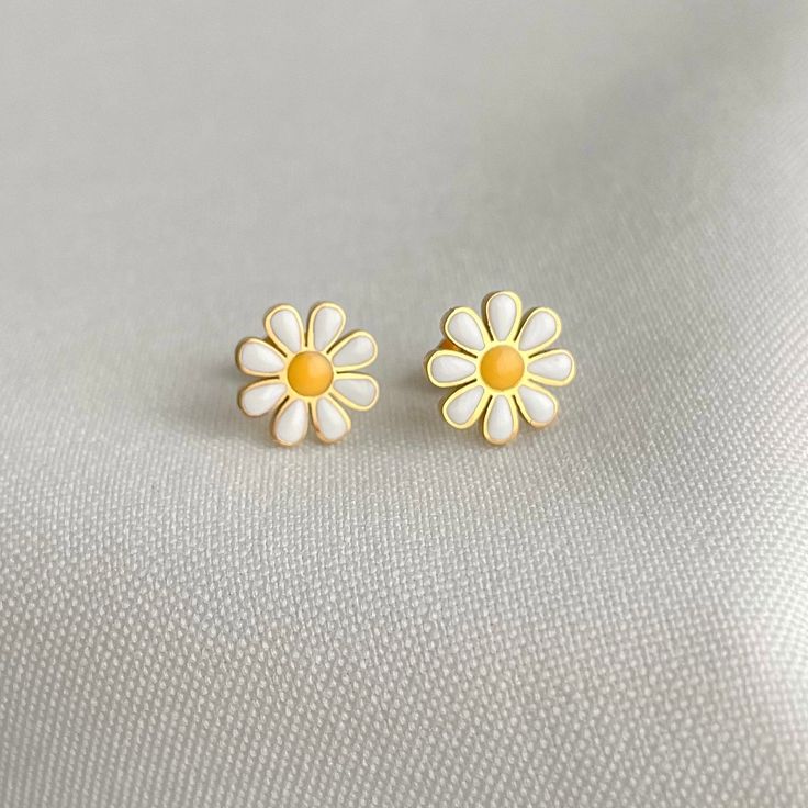 Daisy Earrings, a stunning accessory that effortlessly combines elegance and nature-inspired design. These unique earrings are a true testament to the beauty and vibrancy of daisies, making them a captivating addition to any jewelry collection.  The dainty flowers capture the essence of spring, radiating a sense of joy, freshness, and renewal. With their graceful charm, these earrings are perfect for adding a touch of femininity and sophistication to any outfit. ◆ Sold as a pair. ◆ Stainless Steel ◆Unique design ◆ Gold plated Packaging: All our jewellery comes in velvet bag or a jewelry box Thank you so much for visiting our store enjoy shopping with us ❤️ Stainless Steel Daisy Earrings, Daisy Flowers Earrings, Stud Daisy Earrings, Minimalist Women Earrings, Minimalist Stud Daisy Earrings White Flower Earrings As Gift For Her, Nature-inspired White Drop Earrings, White Nature-inspired Drop Earrings, Sterling Silver White Birth Flower Earrings, Minimalist Flower Earrings, Minimalist White Flower-shaped Earrings, Minimalist Hypoallergenic Flower Earrings, White Birth Flower Earrings In Nature-inspired Style, White Birth Flower Earrings, Nature-inspired