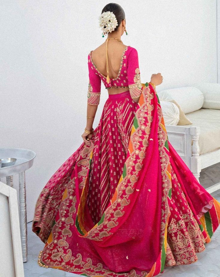 Pink and Yellow Lehenga Choli for Indian Wedding Wear is designed in raw silk fabric with a heavy worked base on lehnga choli in pink with net chiffon dupatta. Choli: Pink Lehenga Choli for Indian wedding wear centers on styles and cuts depicting that time in the past through whimsical fabrics and subdued color schemes. A traditional lehenga choli is something that never goes out of style and this piece is beyond beautiful with its use of chikan Kaari, mirror work, and resham knots, it is simply Pink Dola Silk Chandbali Lehenga, Pink Sets With Dabka Work For Wedding, Pink Art Silk Choli With Dori Work, Pink Choli With Resham Embroidery, Pink Dabka Work Traditional Wear In Dola Silk, Pink Dola Silk Traditional Wear With Dabka Work, Pink Traditional Wear With Dabka Work In Dola Silk, Pink Dola Silk Choli With Zari Work, Pink Raw Silk Sharara With Dabka Work