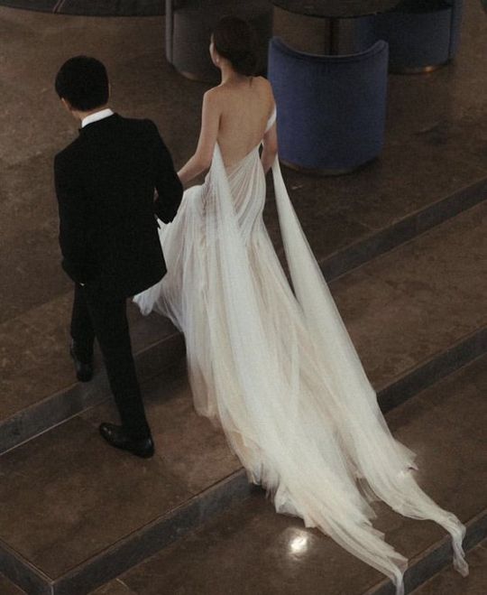 a man and woman walking down some steps