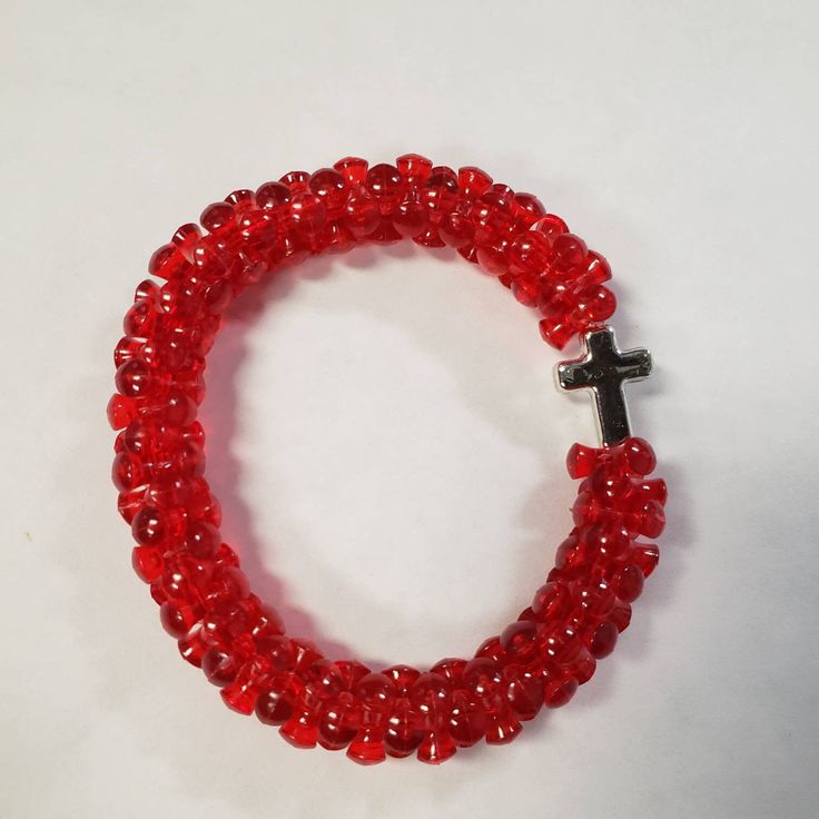 Handmade  Red Tri-bead Bracelet With  Silver Cross Handmade Adjustable Red Stretch Bracelet, Adjustable Red Handmade Stretch Bracelet, Adjustable Handmade Red Stretch Bracelet, Adjustable Red Faceted Beads, Traditional Red Faceted Beads Bracelet, Red Faceted Beads Bracelet, Adjustable Red Stretch Bracelet With Heart Beads, Red Crystal Bracelet With 8mm Beads, Red Spiritual Crystal Bracelet With Round Beads