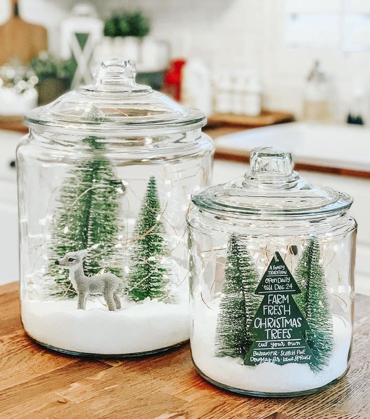 two glass jars with christmas trees in them