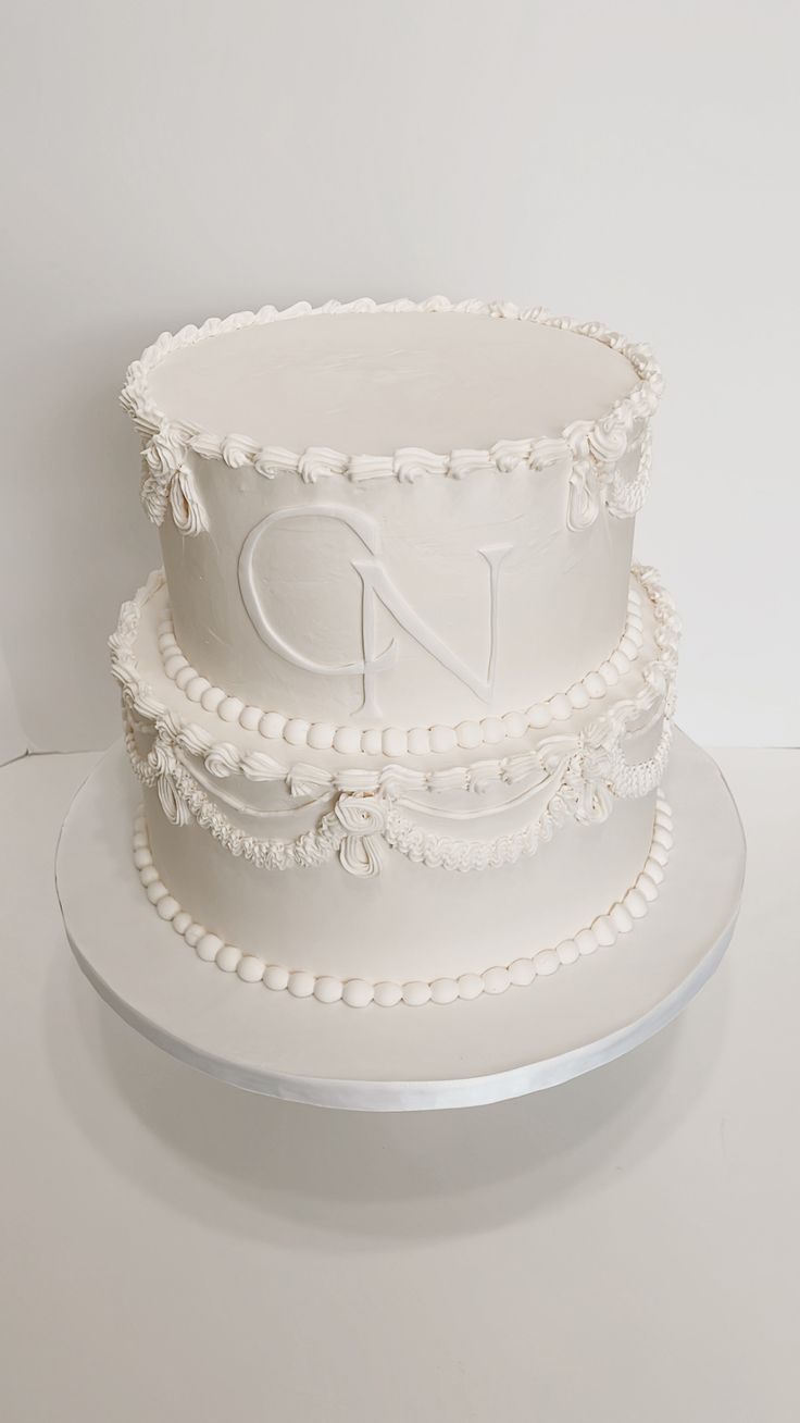 two tiered white cake with beaded decoration