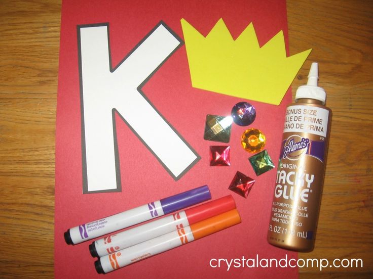 craft supplies laid out on top of a red paper with the letter k in it