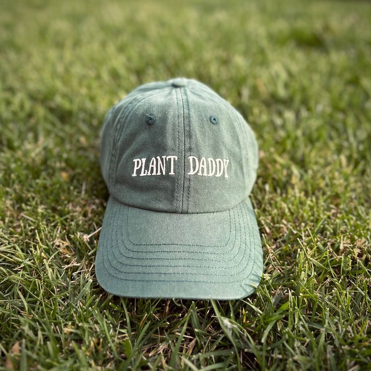 Introducing the cozy and stylish Plant Daddy hat from Plant Scouts - your one-stop-shop for all things plants. This hat is not only a functional accessory to protect you from the sun while you care for your indoor oasis, but it also serves as a reminder of your love and dedication to your beloved plants. The playful "Plant Daddy" text on the hat brings a smile to your face and lets others know that you're proud of your green thumb. So, whether you're relaxing in your backyard or tending to your Comfortable Curved Brim Hat, Eco-friendly Curved Brim Hat For Outdoor, Eco-friendly Curved Brim Outdoor Hat, Green Brimmed Everyday Hat, Green Brimmed Hat For Everyday Wear, Green Visor Hat For Everyday, Comfortable Outdoor Hat With Curved Brim, Everyday Brimmed Dad Hat, Green Adjustable Dad Hat