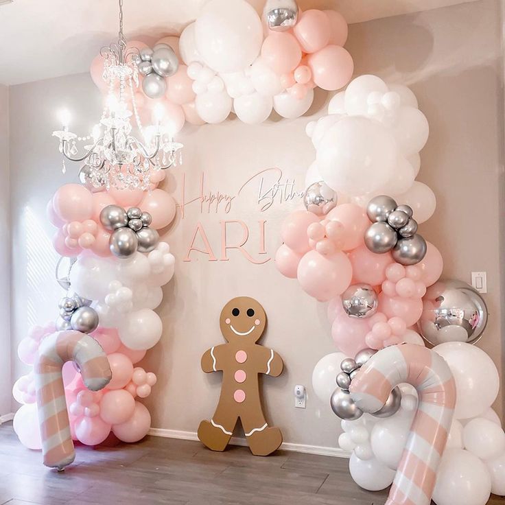 a room decorated with balloons and gingerbreads for a birthday or baby's first birthday