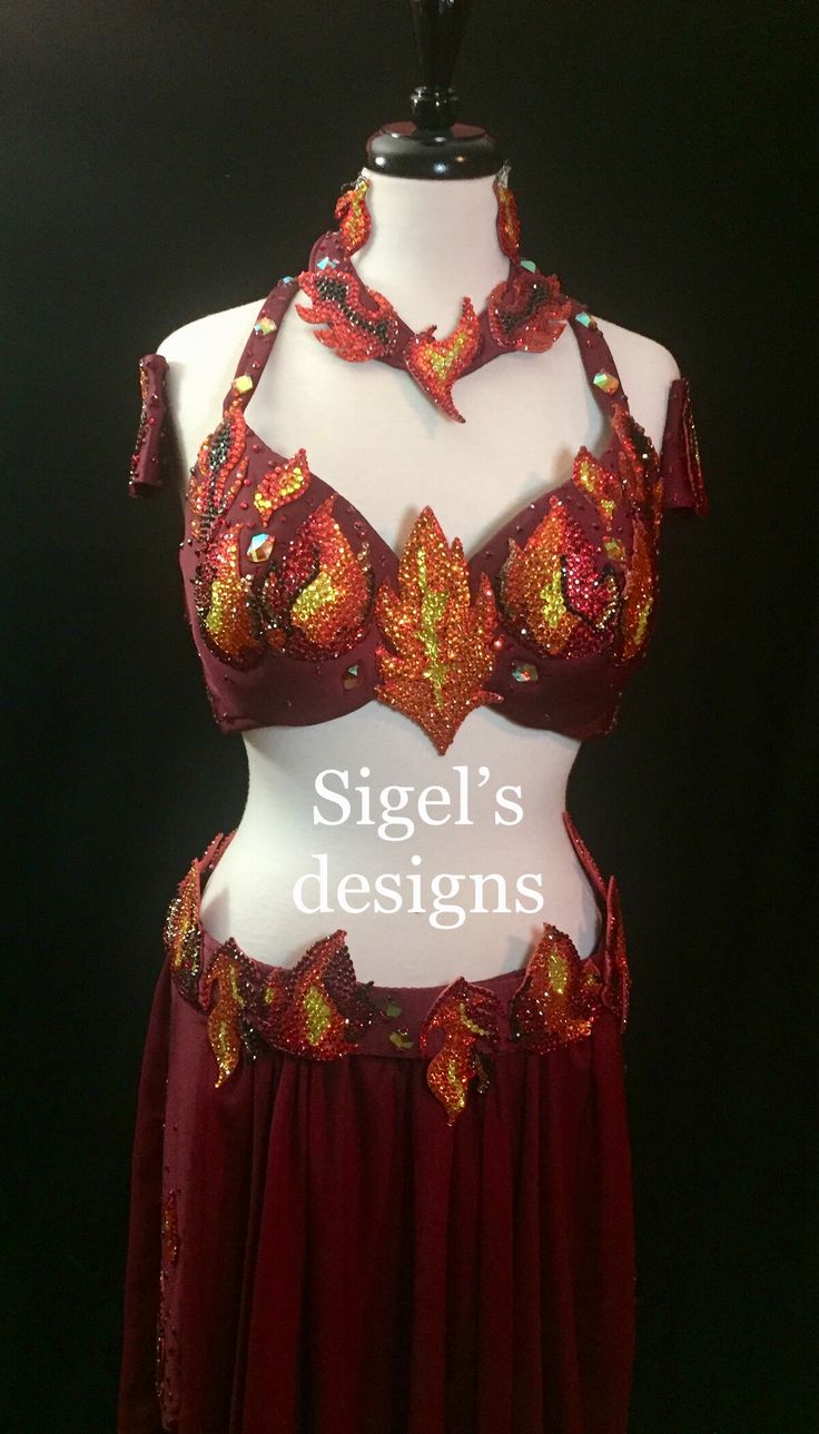 a woman's bra and skirt on display in front of a black background with the words sigel's designs